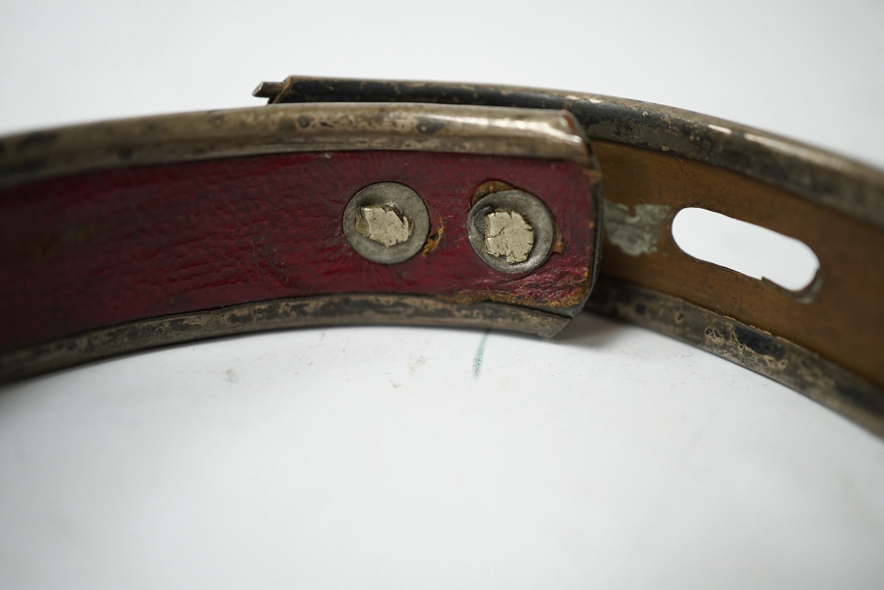 An 18th century Old Sheffield Plate and leather dog collar, 8.5cm in diameter. Condition - fair